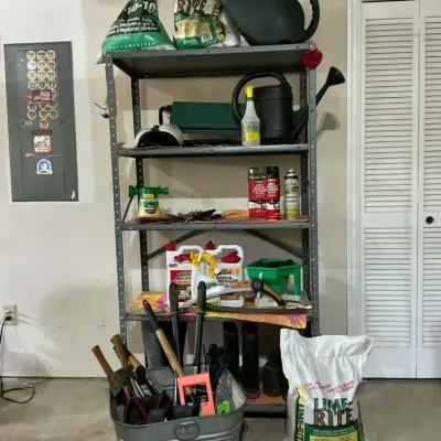 Metal Shelving Unit with Gardening Tools and Lawn Care Supplies