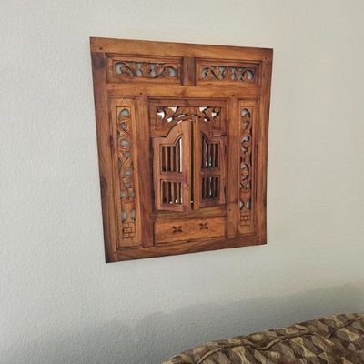 Hand-carved wooden wall mirror featuring a rustic, window-style design with functional shutter doors and intricate openwork details.