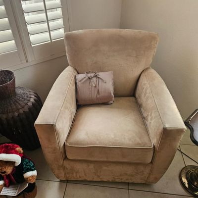 Contemporary beige microfiber armchair with a matching throw pillow, 