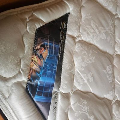 Serta Perfect Sleeper Ultimate mattress featuring a white quilted floral pattern cover.