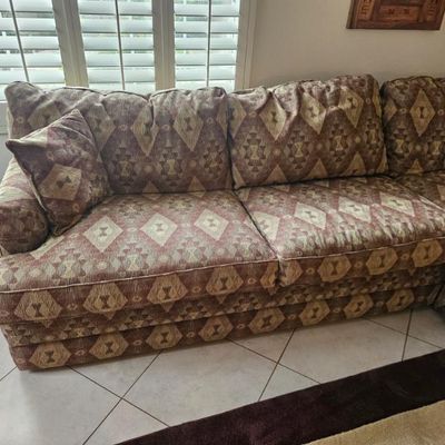 Southwestern-style sectional sofa featuring a geometric diamond pattern in earth tones of brown, tan, and rust.