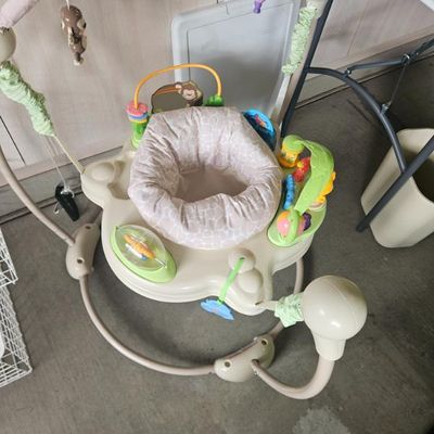 Fisher-Price baby jumperoo activity center with a rotating seat, hanging toys, and interactive play stations.