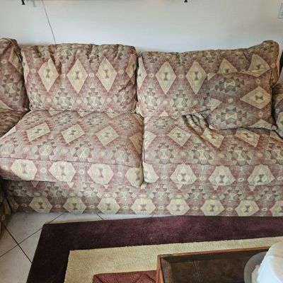 Sectional  Lazy Boy sleeper sofa featuring a southwestern-style geometric pattern in muted red, tan, and brown tones, complete with...