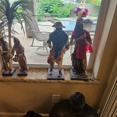 Four vintage Mexican paper mache figurines depicting traditional street vendors