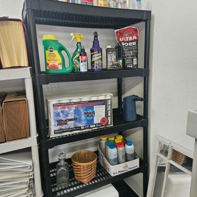 Black plastic five-tier shelving unit holding various household cleaners, pool chemicals, and replacement filters.