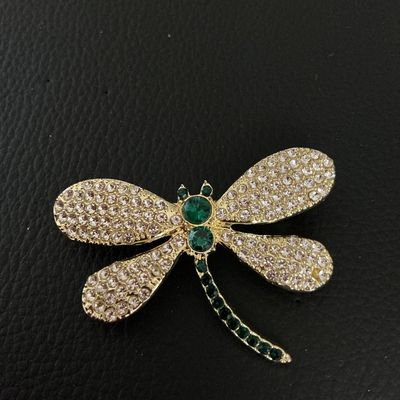 Gold-Tone Rhinestone Dragonfly Brooch with Green Accents