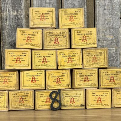 A Collection of Belknap Hardware and Manufacturing Company Cast Aluminum House Numbers in Original Packaging