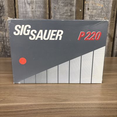 A Group of Sig Sauer P220 Factory Packaging and Paperwork