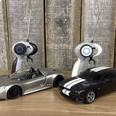 Two Auldey Remote Controlled Toy Cars with Transmitters
