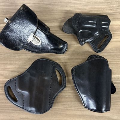 A Collection of Black Leather Firearm Holsters Including Bianchi and Safariland