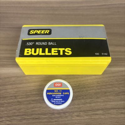 A Box of Speer .530 Inch Round Ball Bullets and a Tin of CCI No. 11 Percussion Caps