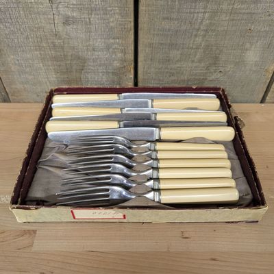 A Set of John Primble Stainless Steel Steak Knives and Forks