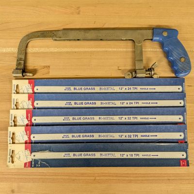 An American Blue Grass Adjustable Hacksaw Frame and a Collection of Bi-Metal Blades