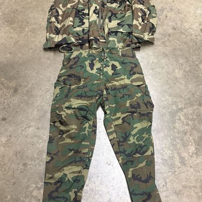 Two Pieces of US Military Woodland Camouflage Cold Weather Clothing Including M-65 Field Coat and Combat Trousers