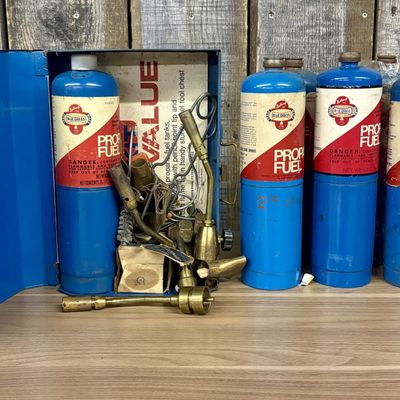 A Group of Belknap Blue Grass Propane Fuel Tanks and Brass Soldering Kit in Metal Chest
