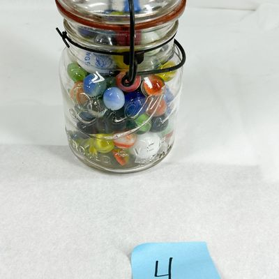 ASSORTMENT OF VINTAGE GLASS MARBLES IN WIRE-BAIL JAR