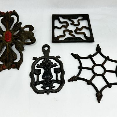 HARRAS AND ASSORTED CAST IRON TRIVETS