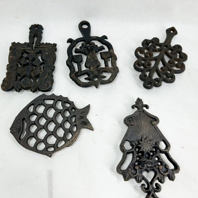 COLLECTION OF DECORATIVE CAST IRON TRIVETS