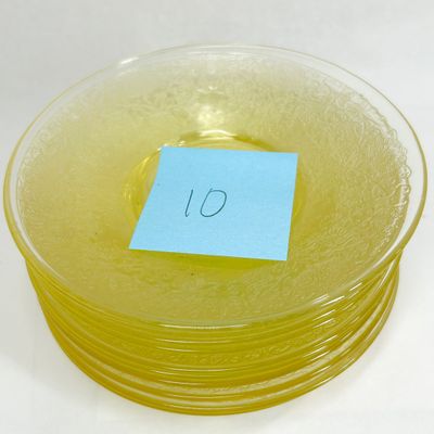 A SET OF YELLOW DEPRESSION GLASS SAUCERS