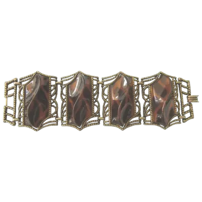 Sale Photo Thumbnail #3: Retro Faux Tortoiseshell Lucite Bracelet
7.5” long
Wonderful very wide 4 section bracelet featuring bold swirl lucite faux tortoise set in bronze tone metal. The bracelet is finished with a foldover clasp.

The bracelet is 2-1/4" wide by 7-1/2" wide. Be