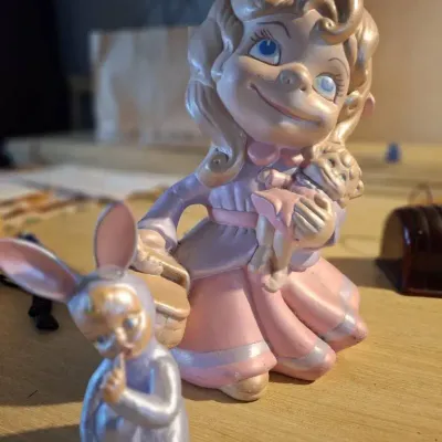 ceramic figurine appears to be a vintage 1970s Atlantic Mold "big-eyed" smiley little girl 