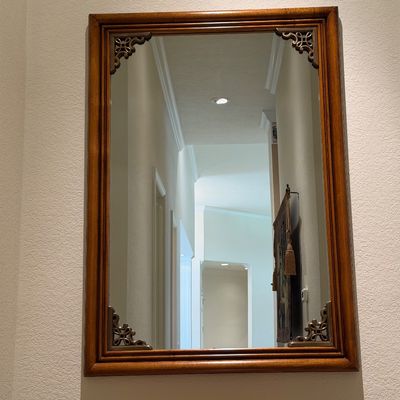 WOODEN LIGHTED LOW CABINET WITH MULTI-PANE GLASS DOUBLE DOORS AND A BEAUTIFUL RECTANGULAR WOOD FRAMED WALL MIRROR ACCENTED WITH ORNATE...