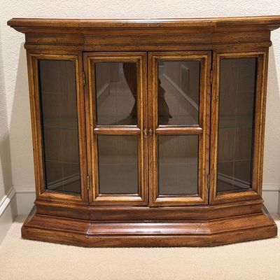 WOODEN LIGHTED LOW CABINET WITH MULTI-PANE GLASS DOUBLE DOORS AND A BEAUTIFUL RECTANGULAR WOOD FRAMED WALL MIRROR ACCENTED WITH ORNATE...
