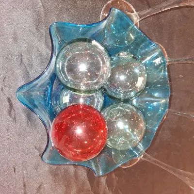 GLASS FLOATS IN A RUFFLED GLASS BOWL PLUS OIL CANDLE LAMPS