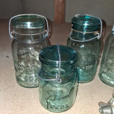 AQUA BLUE CANNING JARS WITH ZINC AND WIRE BALE LIDS PLUS A FOOD CHOPPER