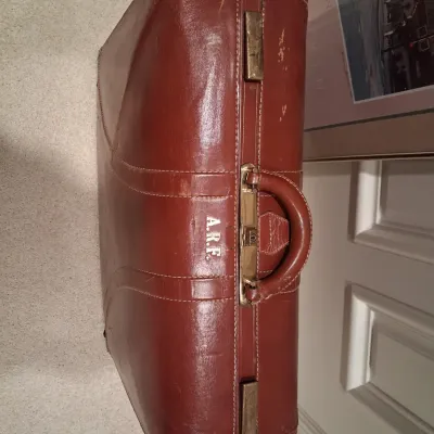 LEATHER SUITCASE AND SIGNED POSTER "PLAZA DAWN"