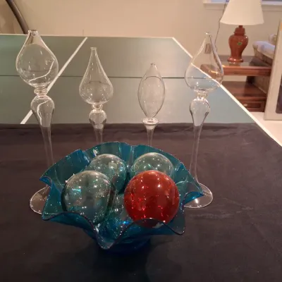 GLASS FLOATS IN A RUFFLED GLASS BOWL PLUS OIL CANDLE LAMPS