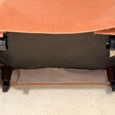 WOODMARK ORIGINALS VINTAGE PEACH VELVET TUFTED BARREL ARMCHAIR ON CASTERS AND ARTIFICIAL PLANT CLIMBING A METAL OBELISK TRELLIS