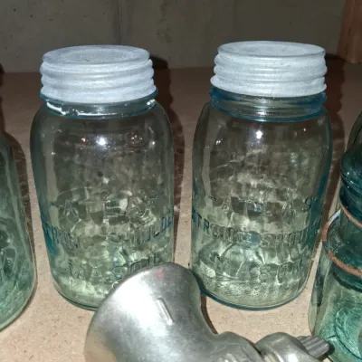 AQUA BLUE CANNING JARS WITH ZINC AND WIRE BALE LIDS PLUS A FOOD CHOPPER