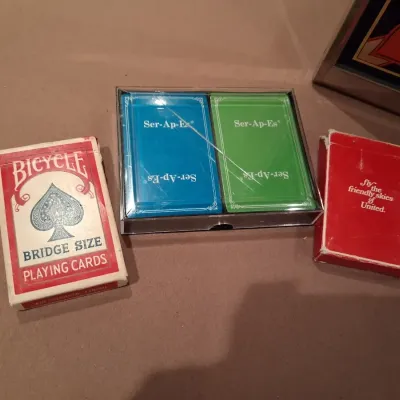 1935 MONOPOLY GAME AND ANTE-UP-RUMMY BOARD WITH MARBLES STORED IN THE FRAME PLUS PLAYING CARDS
