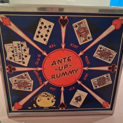 1935 MONOPOLY GAME AND ANTE-UP-RUMMY BOARD WITH MARBLES STORED IN THE FRAME PLUS PLAYING CARDS