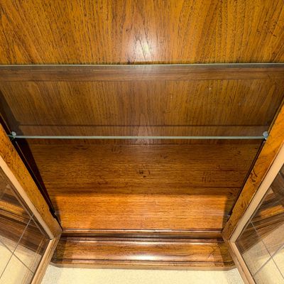 WOODEN LIGHTED LOW CABINET WITH MULTI-PANE GLASS DOUBLE DOORS AND A BEAUTIFUL RECTANGULAR WOOD FRAMED WALL MIRROR ACCENTED WITH ORNATE...