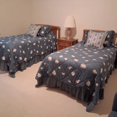 2 MATCHING TWIN BEDS W/CLEAN MATTRESSES, BEDDING, WHITE NIGHT STAND AND LAMP