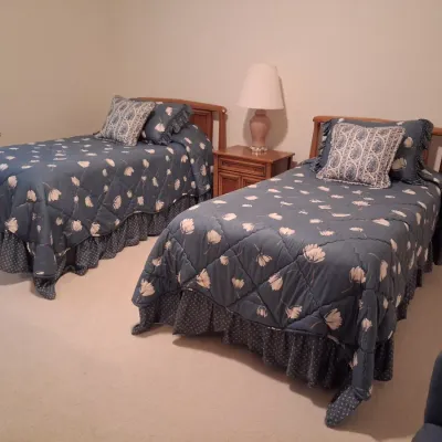 2 MATCHING TWIN BEDS W/CLEAN MATTRESSES, BEDDING, WHITE NIGHT STAND AND LAMP