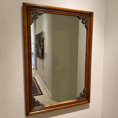 WOODEN LIGHTED LOW CABINET WITH MULTI-PANE GLASS DOUBLE DOORS AND A BEAUTIFUL RECTANGULAR WOOD FRAMED WALL MIRROR ACCENTED WITH ORNATE...