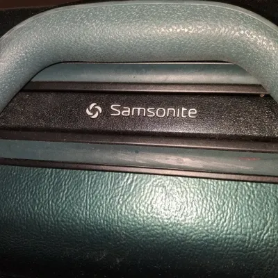 SAMSONITE HARD SIDED SUITCASE ON 4 WHEELS AND A SAMSONITE GARMENT BAG
