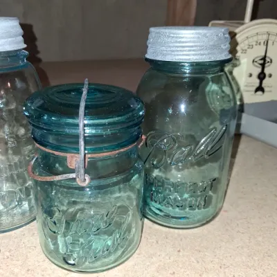 AQUA BLUE CANNING JARS WITH ZINC AND WIRE BALE LIDS PLUS A FOOD CHOPPER