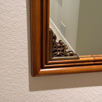 WOODEN LIGHTED LOW CABINET WITH MULTI-PANE GLASS DOUBLE DOORS AND A BEAUTIFUL RECTANGULAR WOOD FRAMED WALL MIRROR ACCENTED WITH ORNATE...