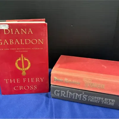 3 Hardback Fantasy Novels - Gabaldon Outlander Fiery Cross & Voyager, Grimm’s Complete Fairy Tales