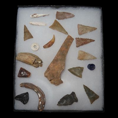 Sale Photo Thumbnail #192: Collection of Cahokia Relics, Shell Pendants, Beads, Teeth, and Triangles, Ex. Charles Wesley Collection