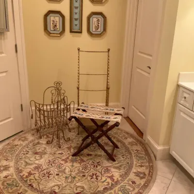 Round Floral Area Rug with Accent Furniture and Framed Artwork