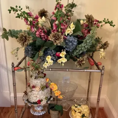 Metal and Glass Serving Cart with Artificial Floral Arrangements