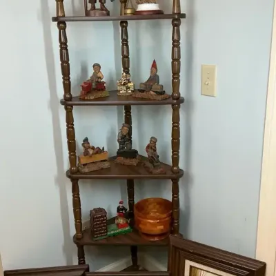 Wooden Corner Shelf with Figurines and Framed Artwork