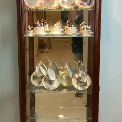 Lighted Curio Cabinet with Teacups and Saucers