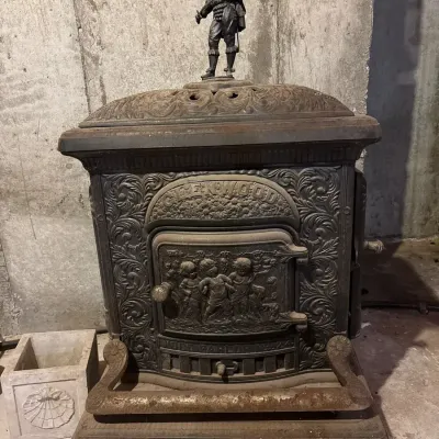 Ornate Antique Cast Iron Stove with Decorative Soldier Finial