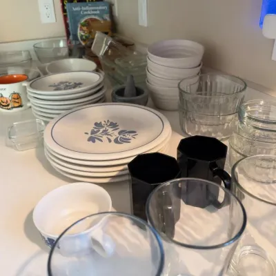 Pfaltzgraff Yorktowne pattern dishes, glass bowls, black mugs